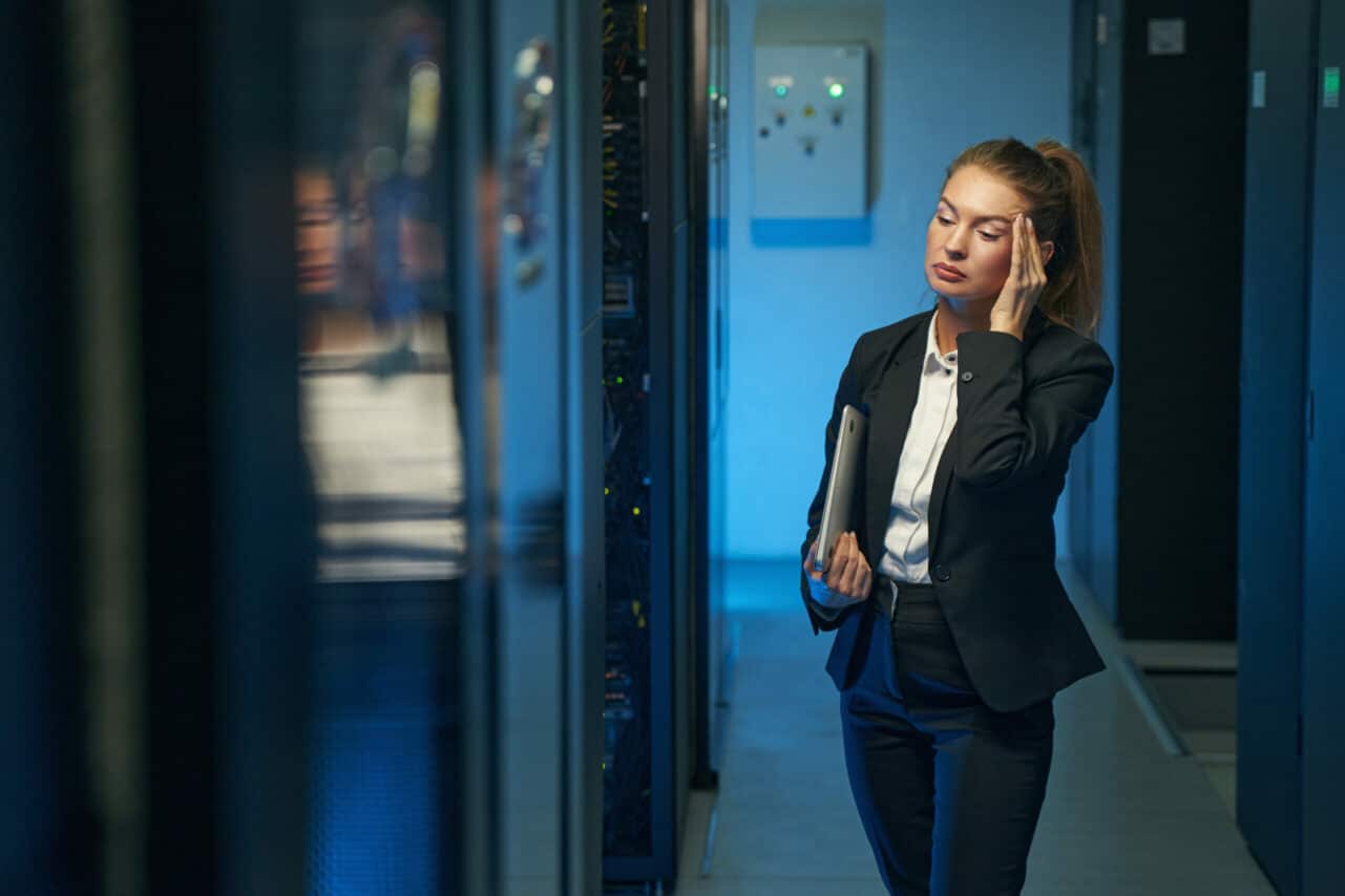 A frustrated woman standing in s data center
