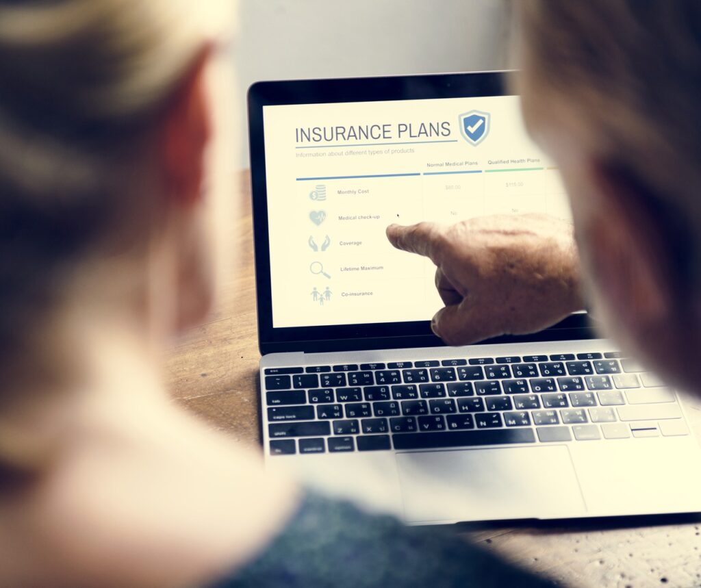 Two people look at a computer page about cyber insurance